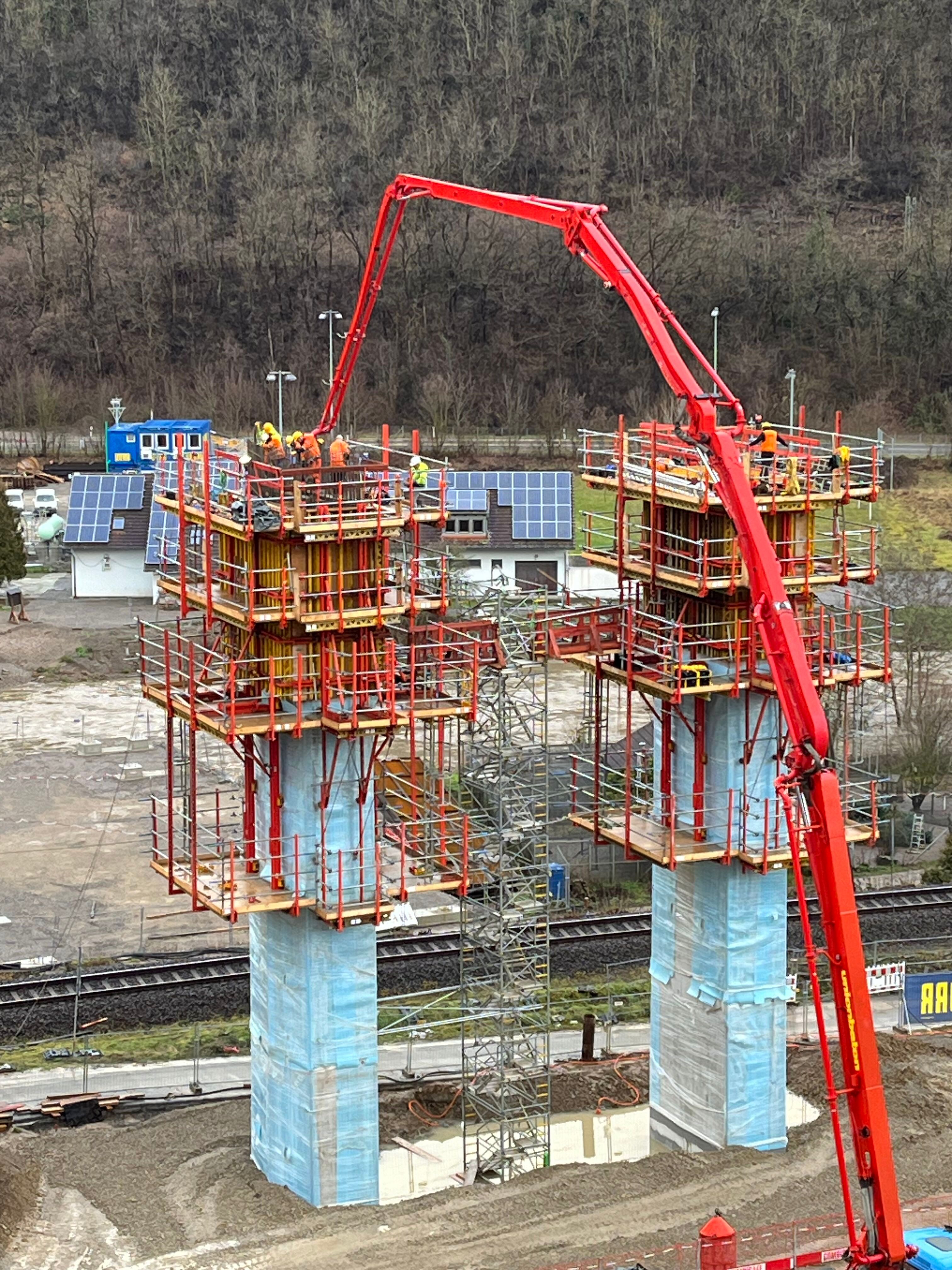 Bauarbeiter pumpen Beton in die Verschalung